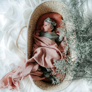 Baby wrapped in ballet blush swaddle