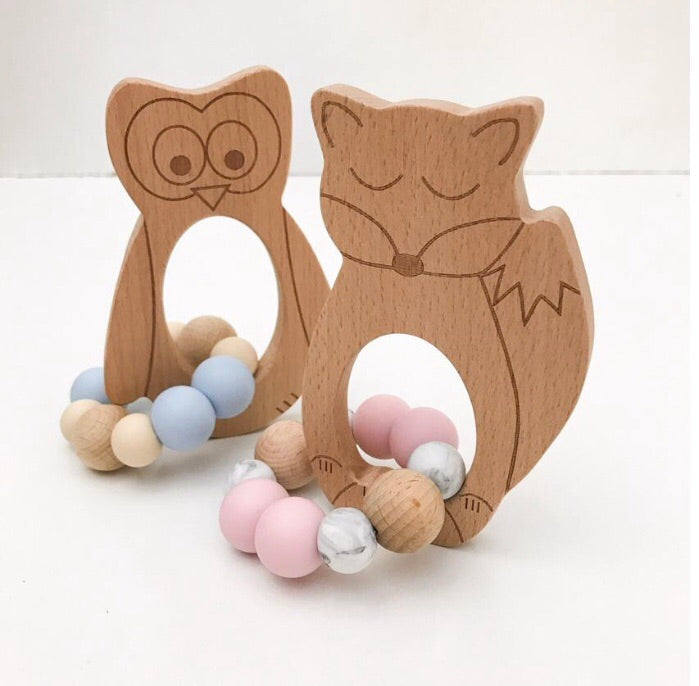 Fox silicone and beech wood teether, pink and white silicone beads and owl beechwood teether in background