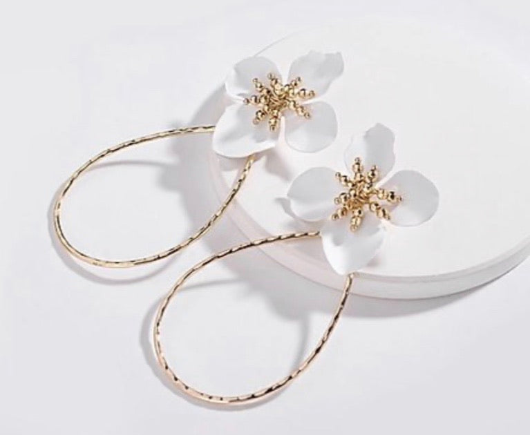 white flower and gold hoop earrings
