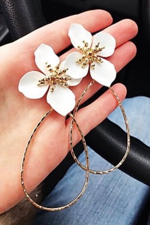 white flower and gold hoop earrings