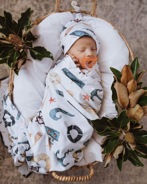 Baby wrapped in the shipwreck jersey swaddle and beanie