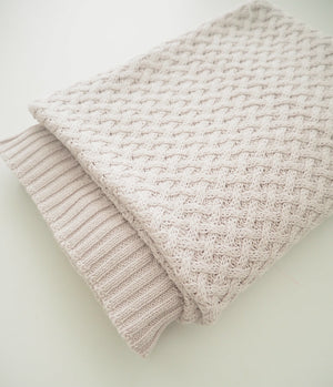 Grey knit blanket folded in a square